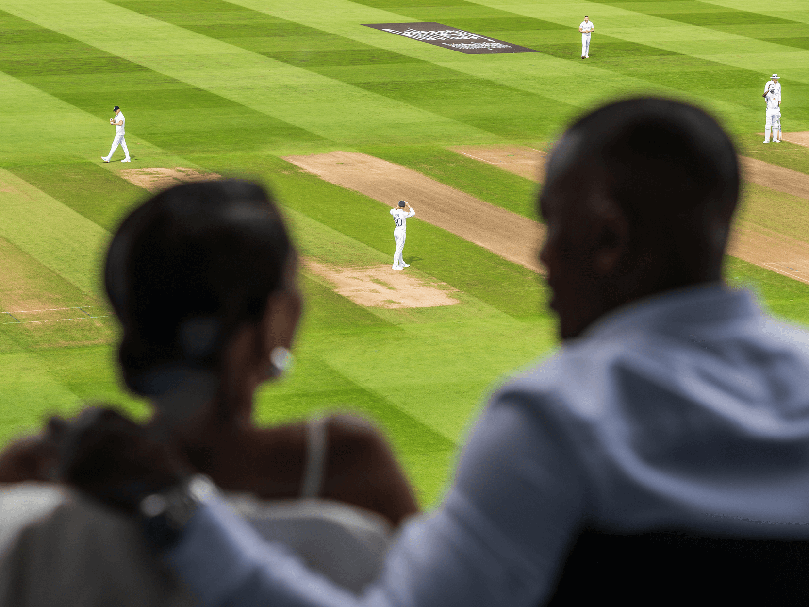 View of Edgbaston Stadium cricket pitch from behind a couple watching the England match from their match seats