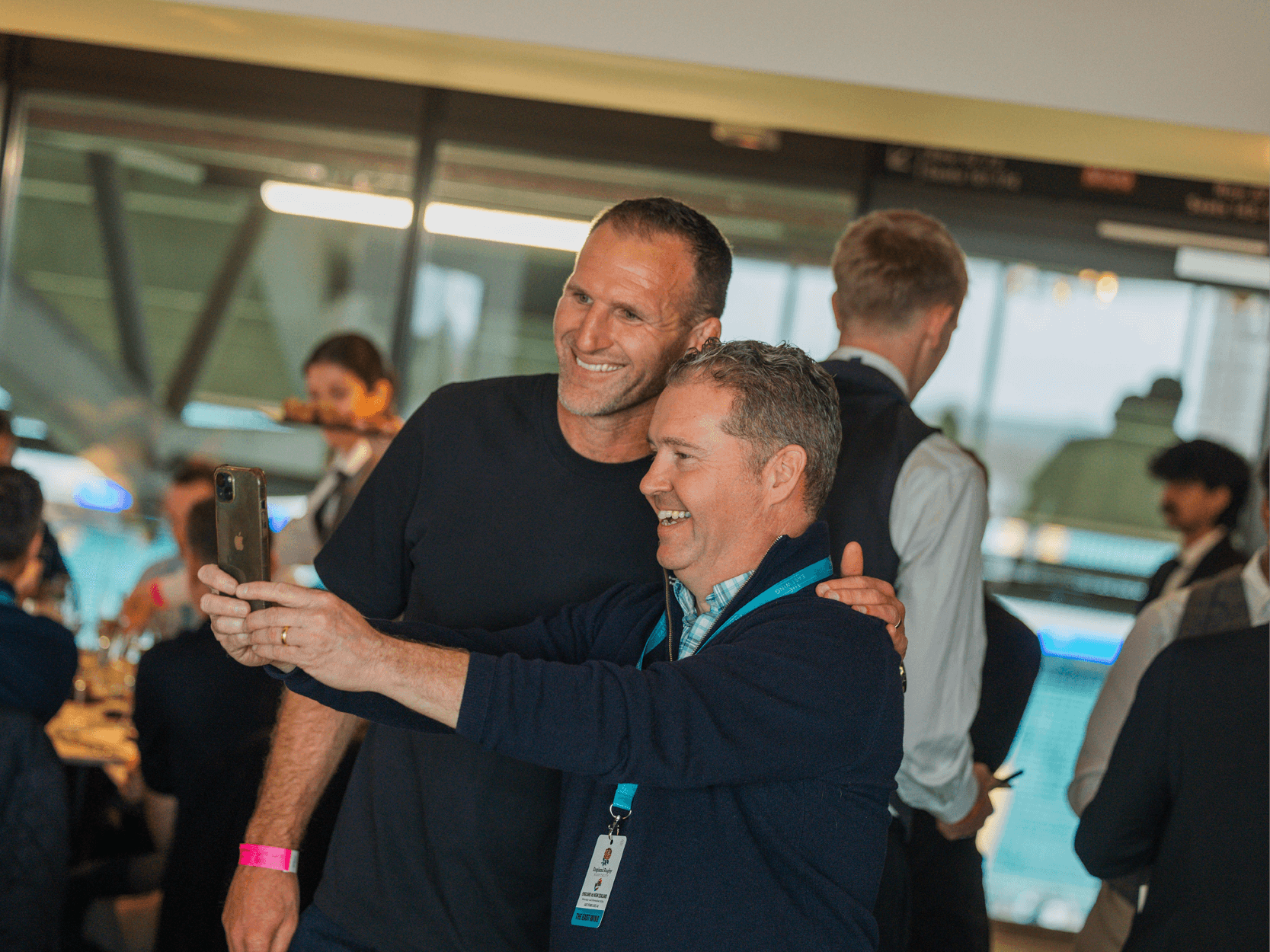 Former New Zealand and All Blacks player Kieran Read smiling with a guest in the East Wing at Allianz Stadium Twickenham
