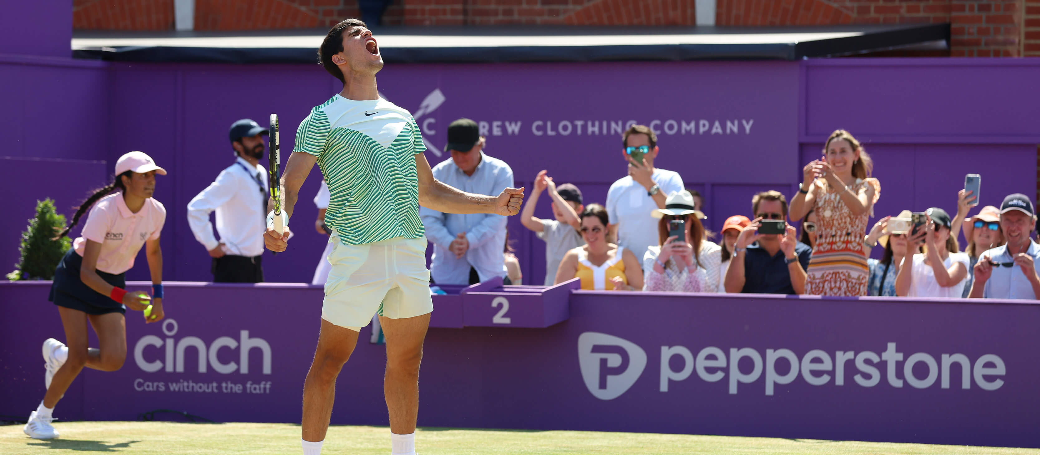 Spanish tennis player Carlos Alcaraz shouting and celebrating scoring a point on court during the 2023 cinch Championships at The Queen's Club in London