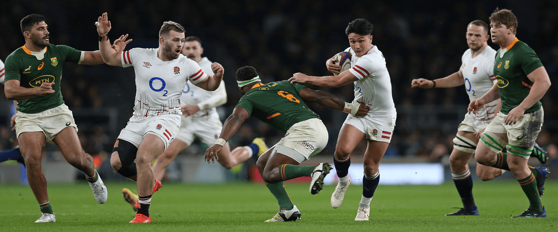 Marcus Smith carrying the ball whilst running to get away from the South African team during a match at Twickenham Stadium