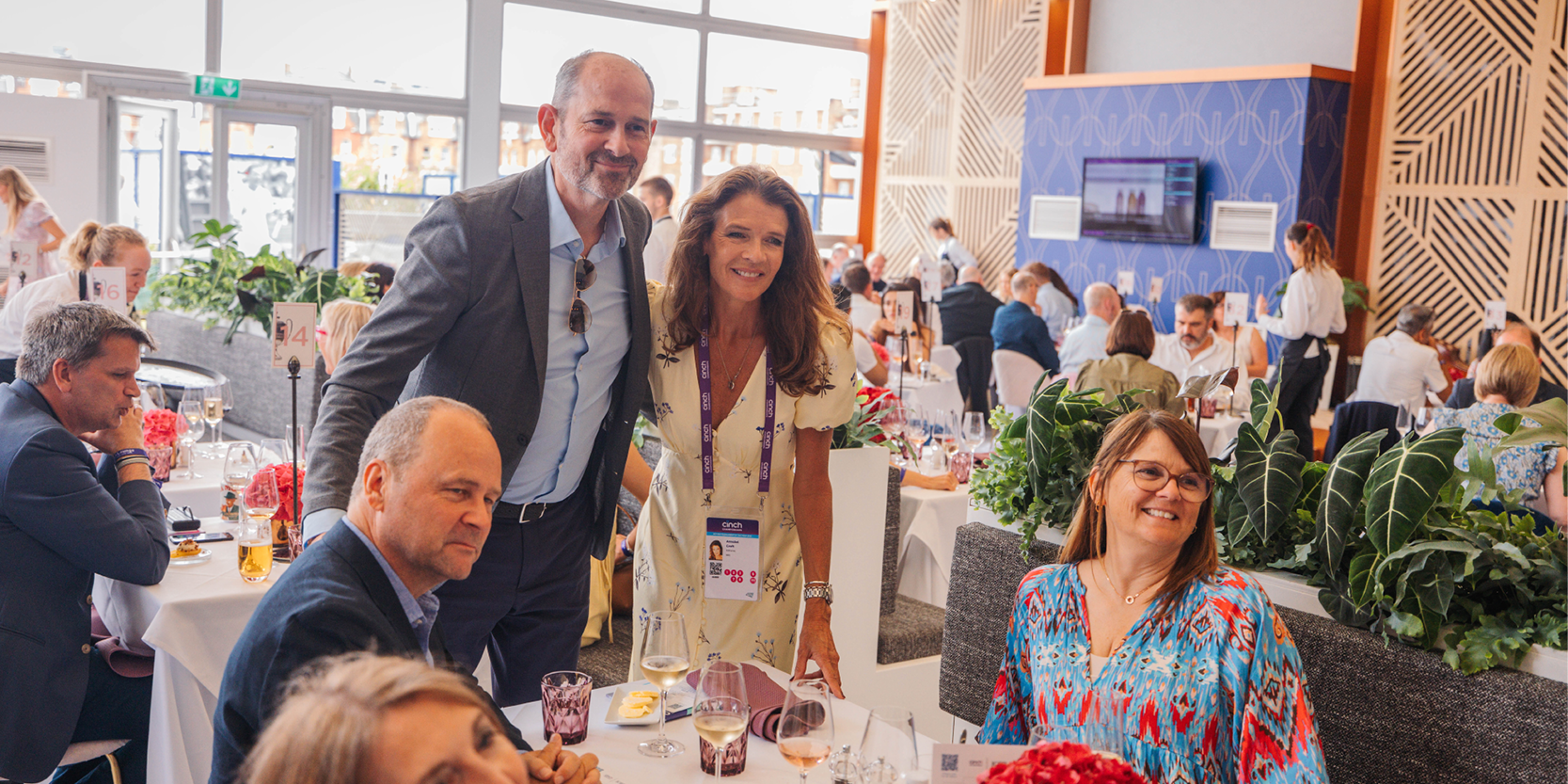Guests in hospitality facility Club Lounge smiling for a photo with former British tennis player and commentator Annabel Croft