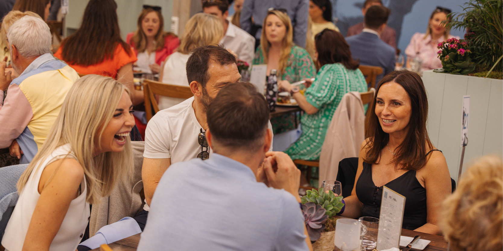 Guests chatting at their table in hospitality area Love Fifteen at The Queen's Club for the Championships tennis