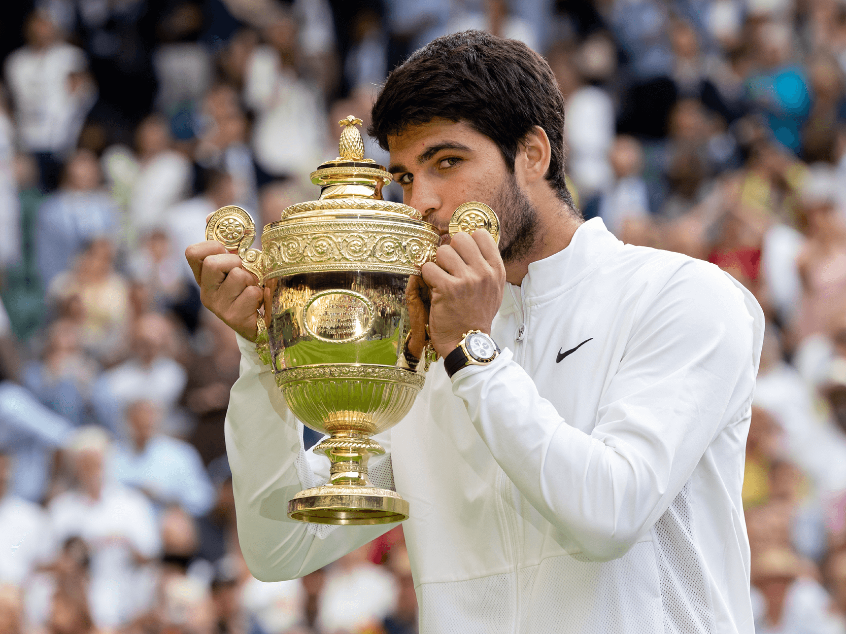 Tennis player and Wimbledon 2023 champion Carlos Alcaraz kissing the Wimbledon trophy on Centre Court in 2023 after beating Novak Djokovic in the final