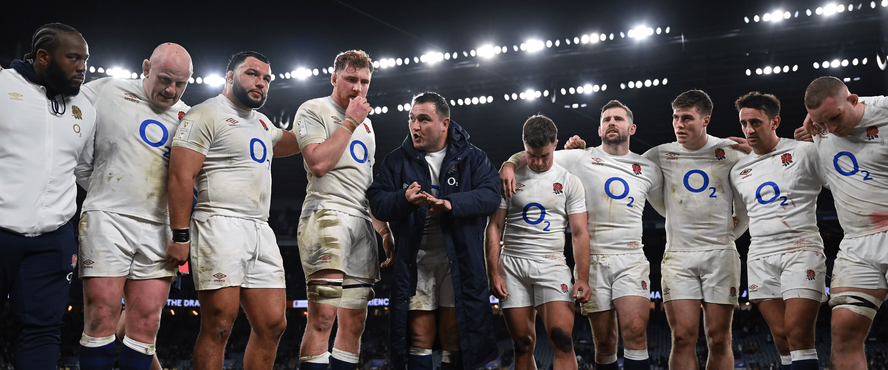 The England Rugby team crowding round having a team talk at half time during a match at Twickenham Stadium with captain Jamie George