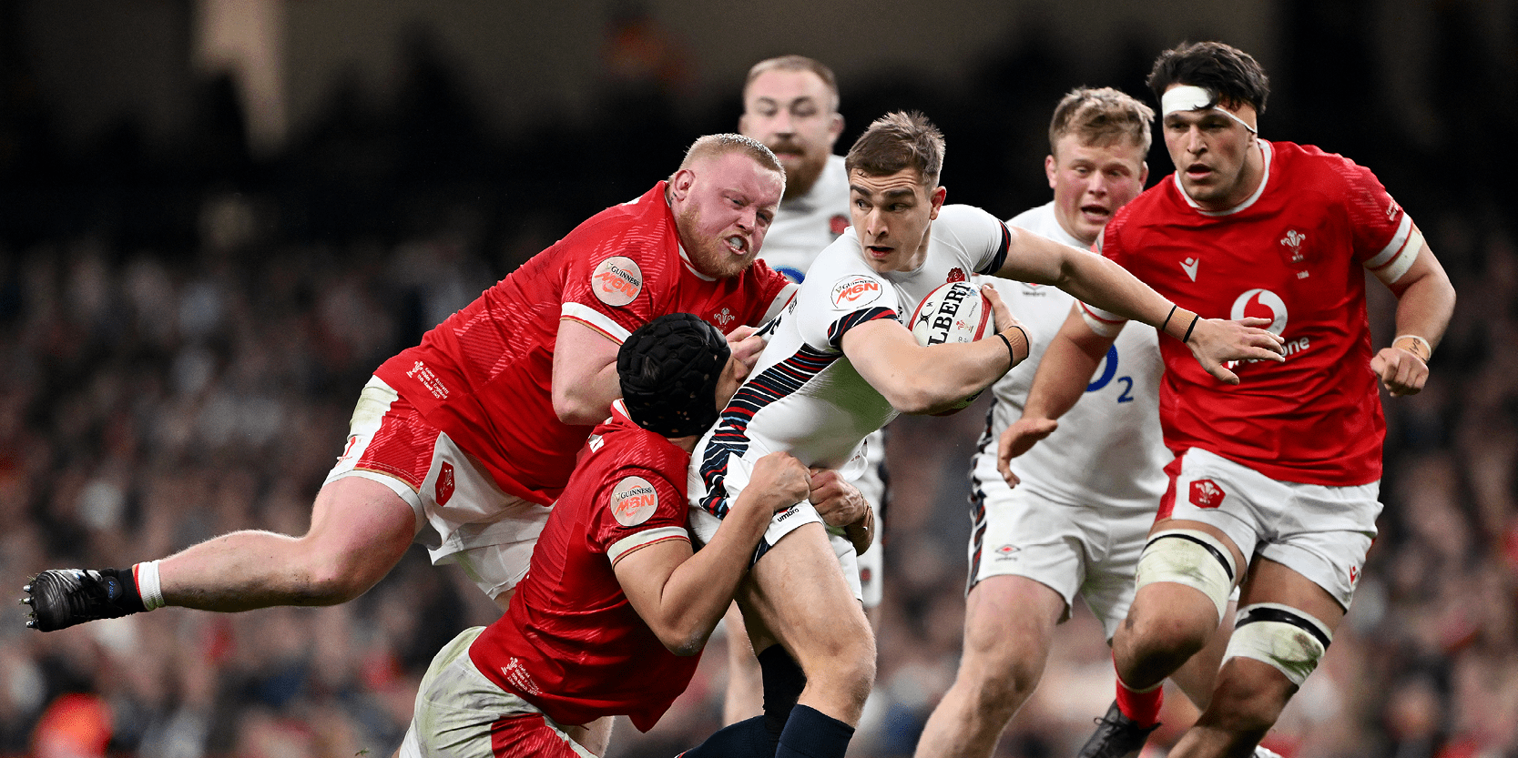 England Rugby player Jack van Poortvliet running with the ball in the 2025 Guinness Men's Six Nations tournament against Wales