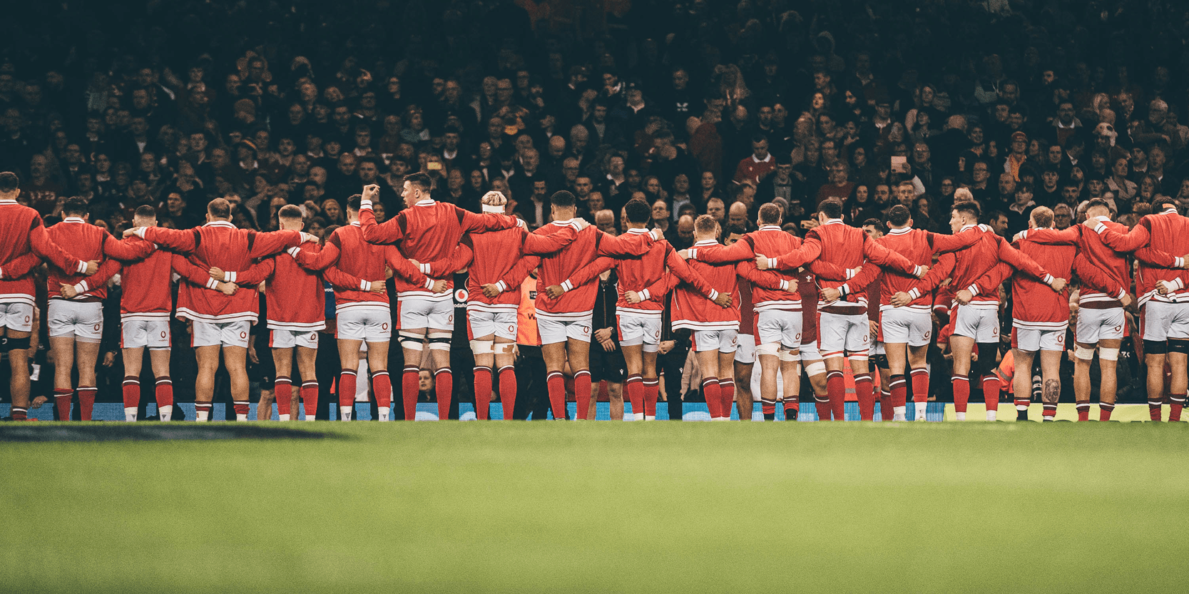 Welsh rugby union team lining up singing that national anthem on the rugby pitch at Principality Stadium in Cardiff