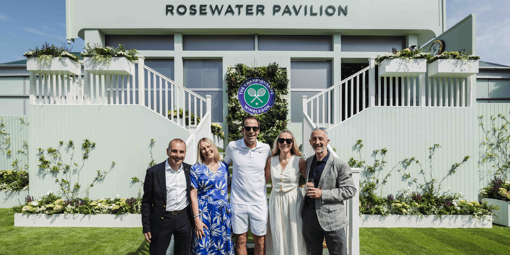 Guests in hospitality at Rosewater Pavilion having a photo with former British tennis player Greg Rusedski at Wimbledon 2025
