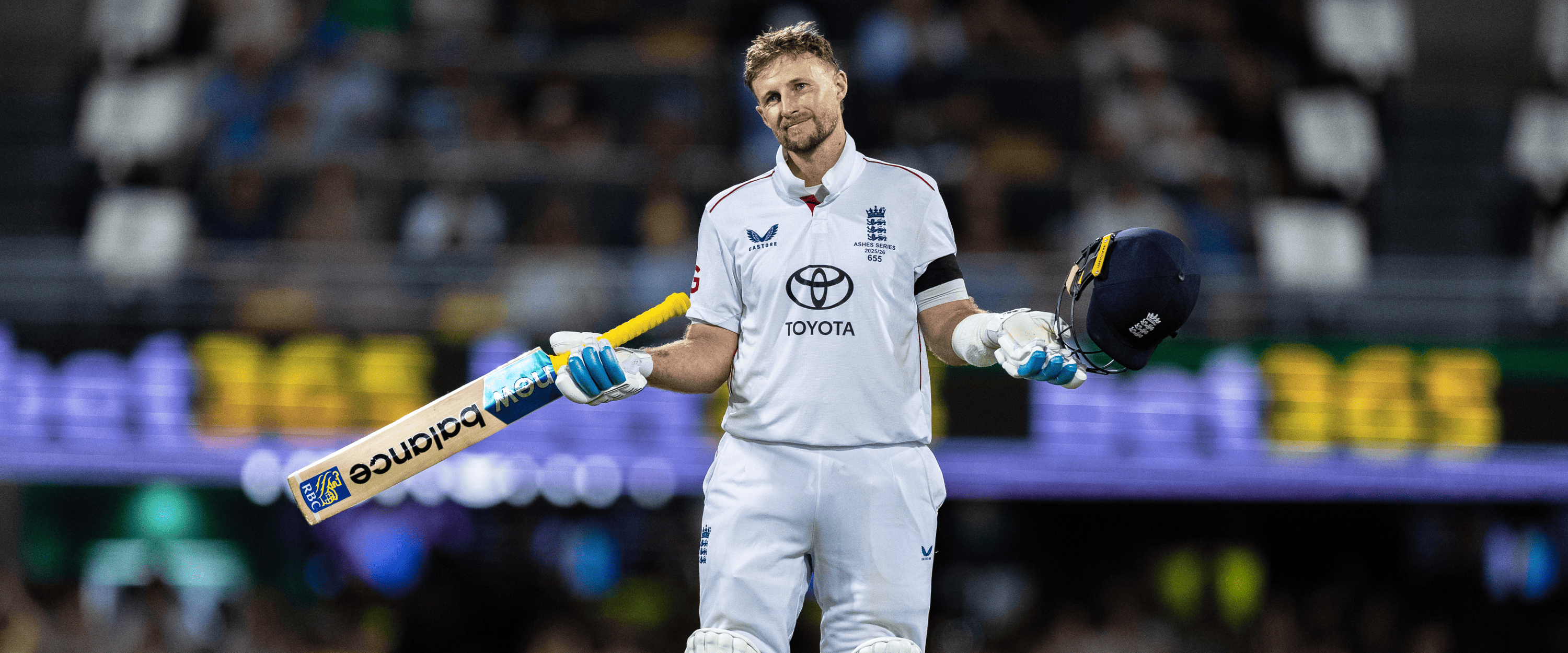 England cricketer Joe Root smiling on the pitch during a cricket match