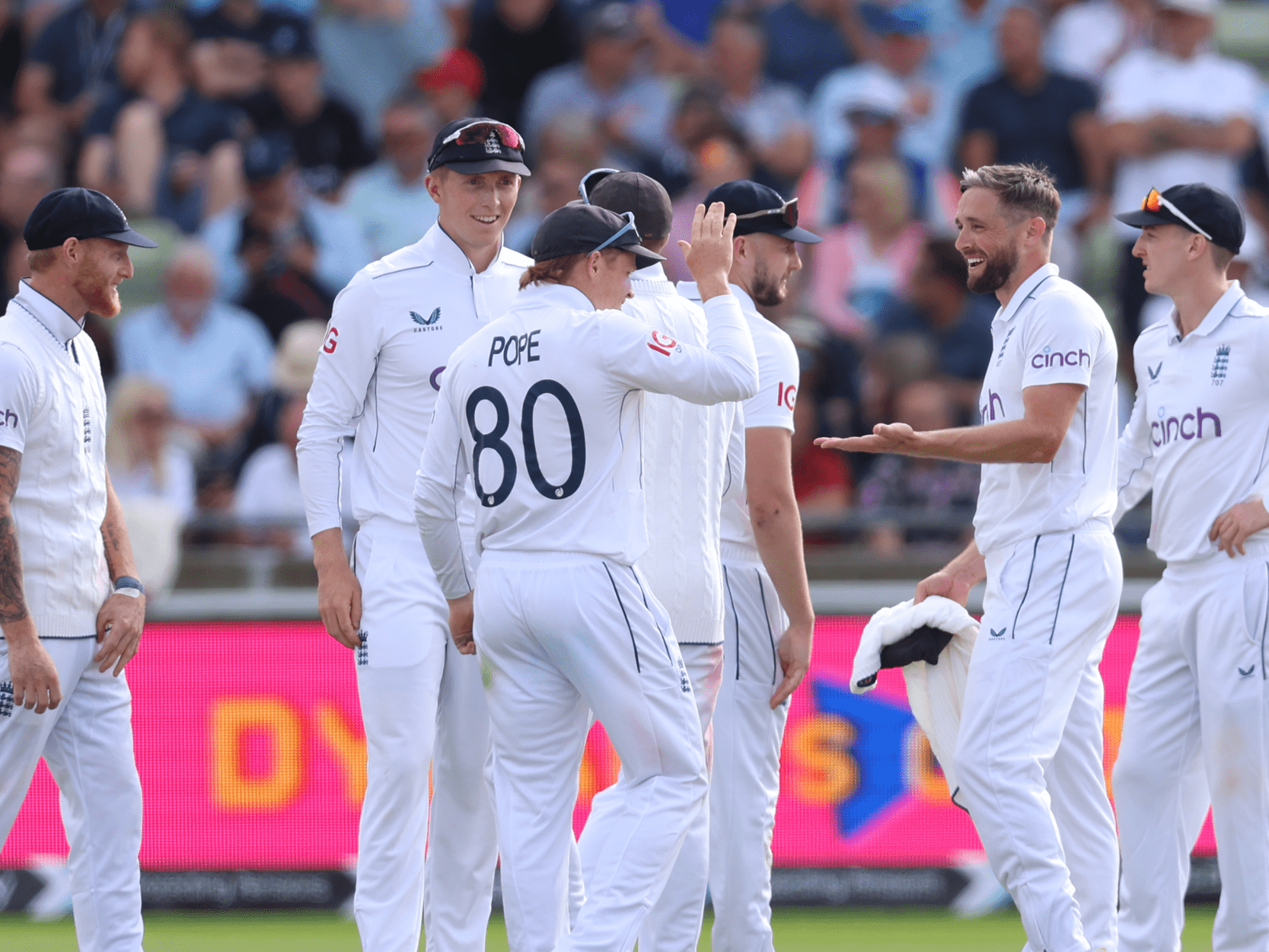 England Cricket team doing high fives and celebrating winning during a Test match