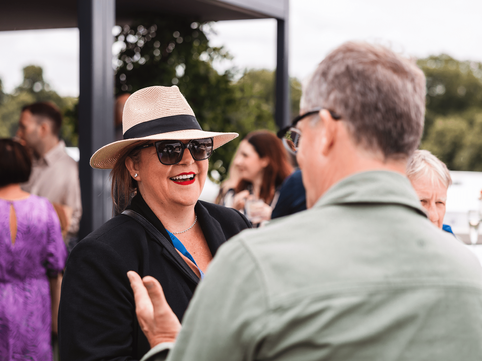 Guests smiling in the Great Oak Roof Garden terrace at BST Hyde Park