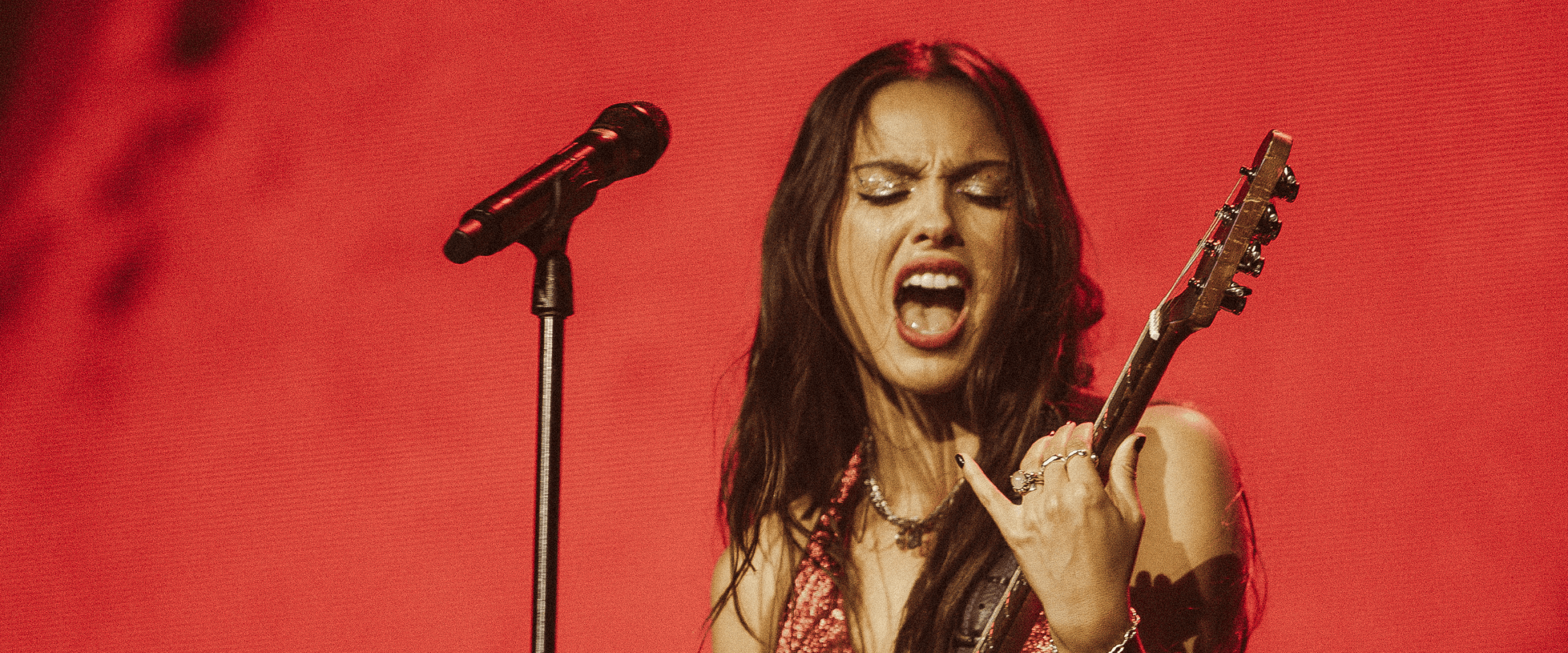 Global singer songwriter and American artist Olivia Rodrigo playing guitar and singing during a performance