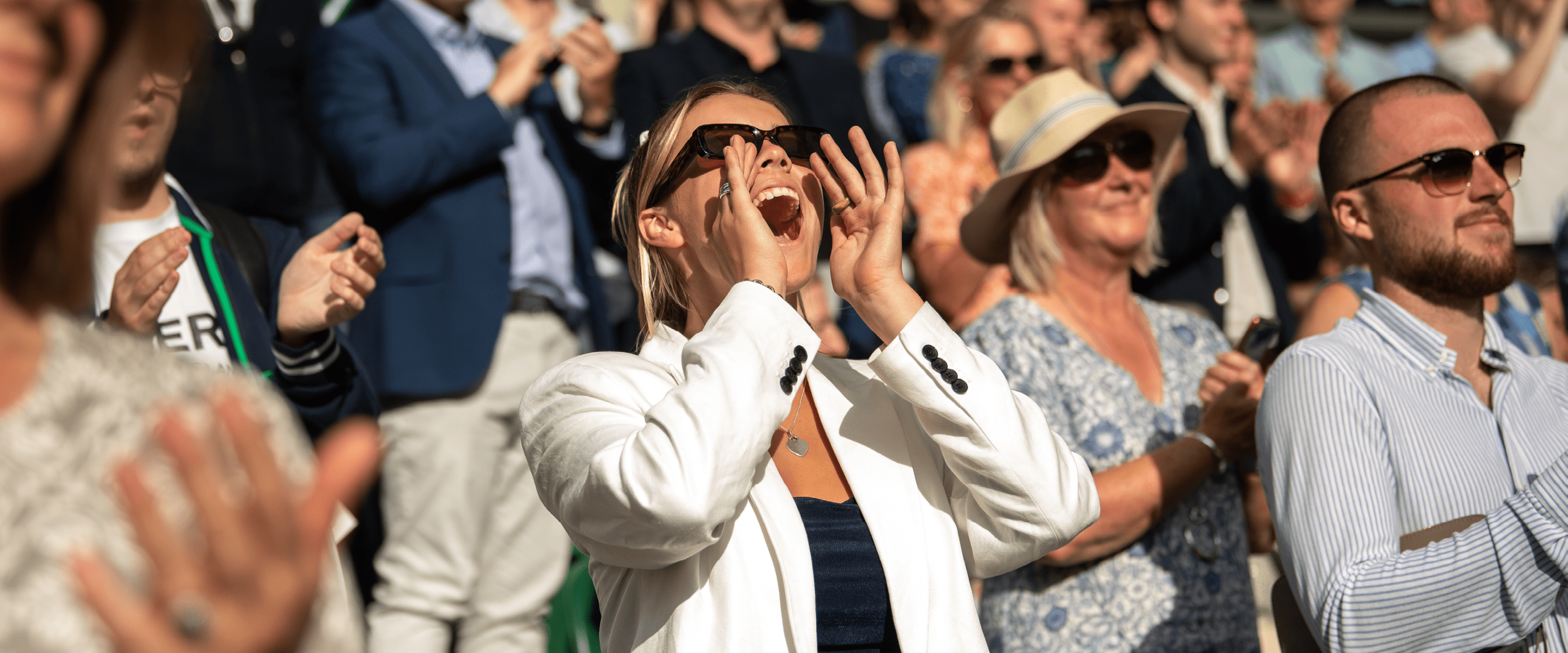 Tennis fan cheering in the crowd on Centre Court at Wimbledon