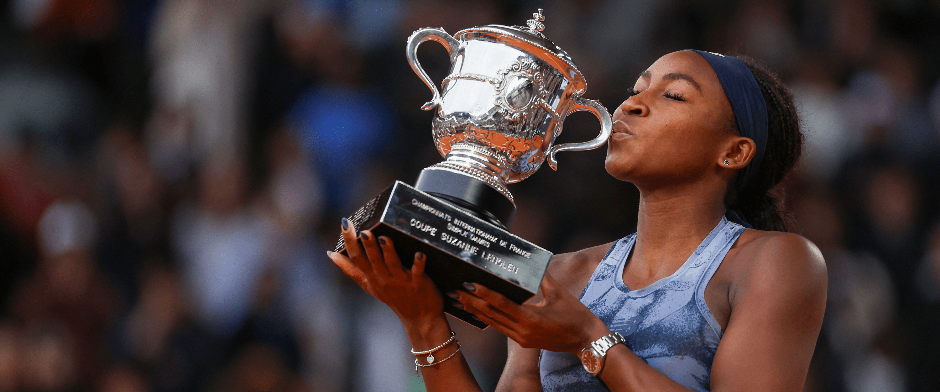 American women's tennis player Coco Gauff kissing the Roland Garros French Open trophy after winning the 2025 tournament against Aryna Sabalenka