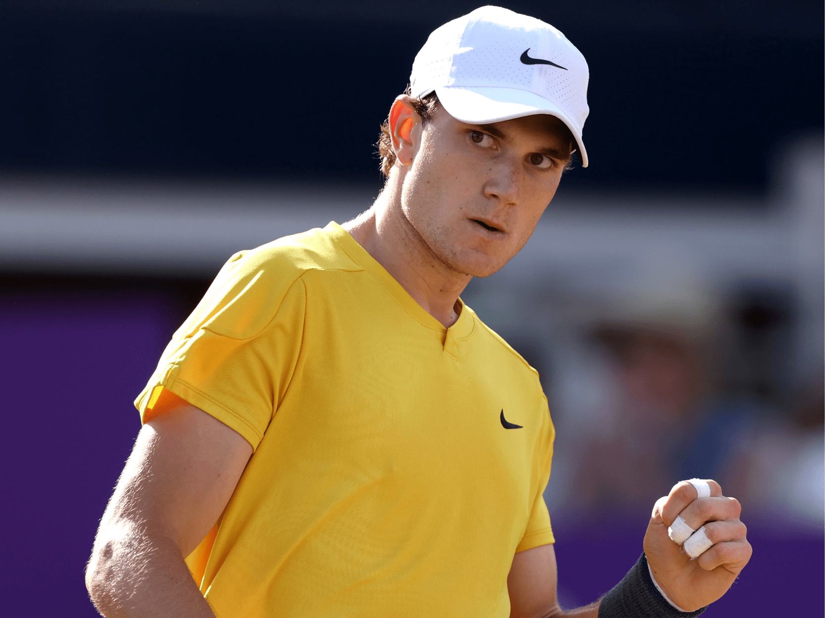 British men's tennis player Jack Draper celebrating a point during a match at the Queen's Club on court