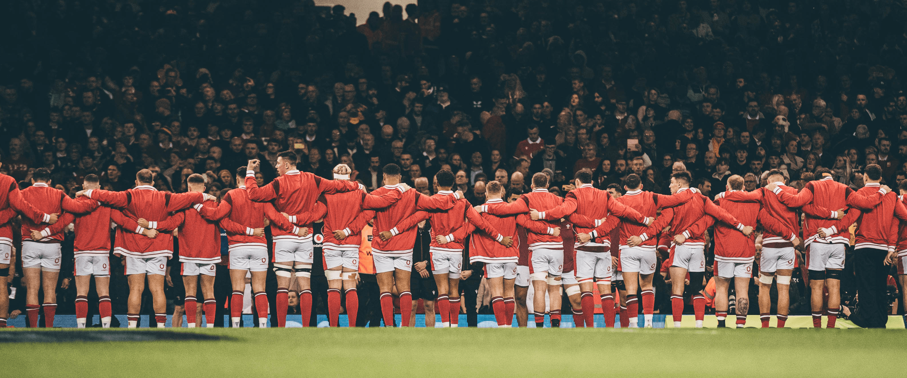 Welsh rugby team lining up to sing the national anthem before a match at Principality Stadium