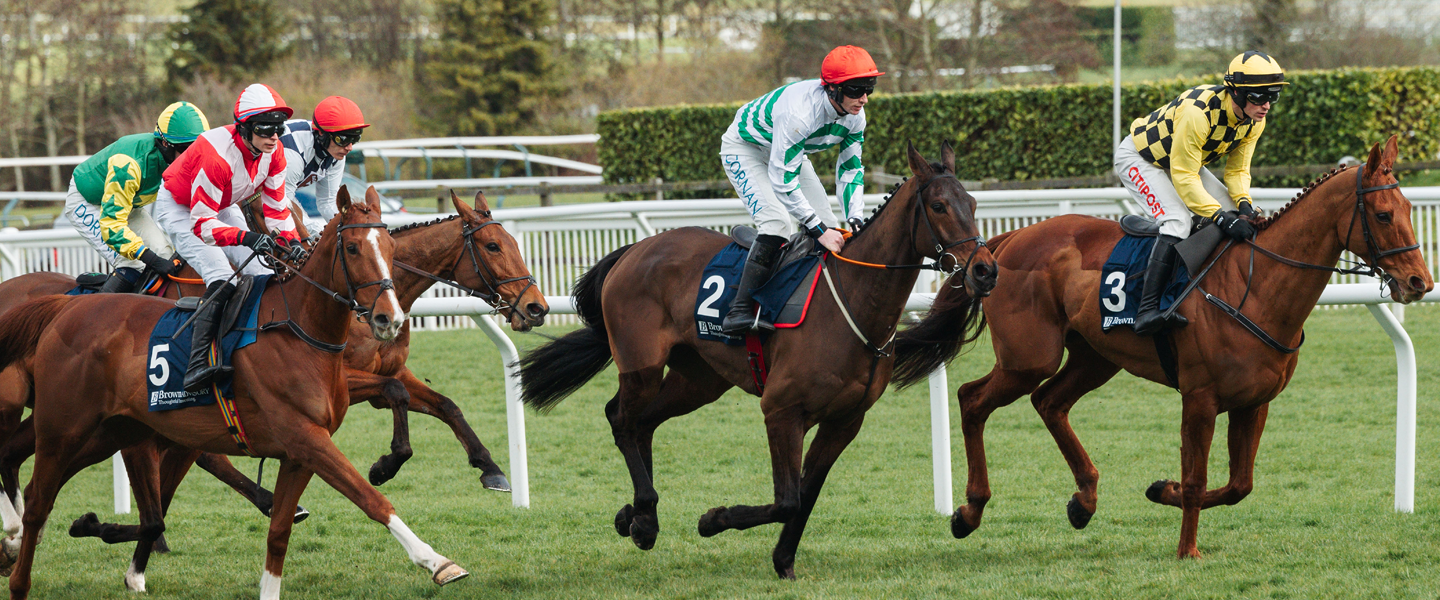 Horses and jockeys racing at Royal Ascot