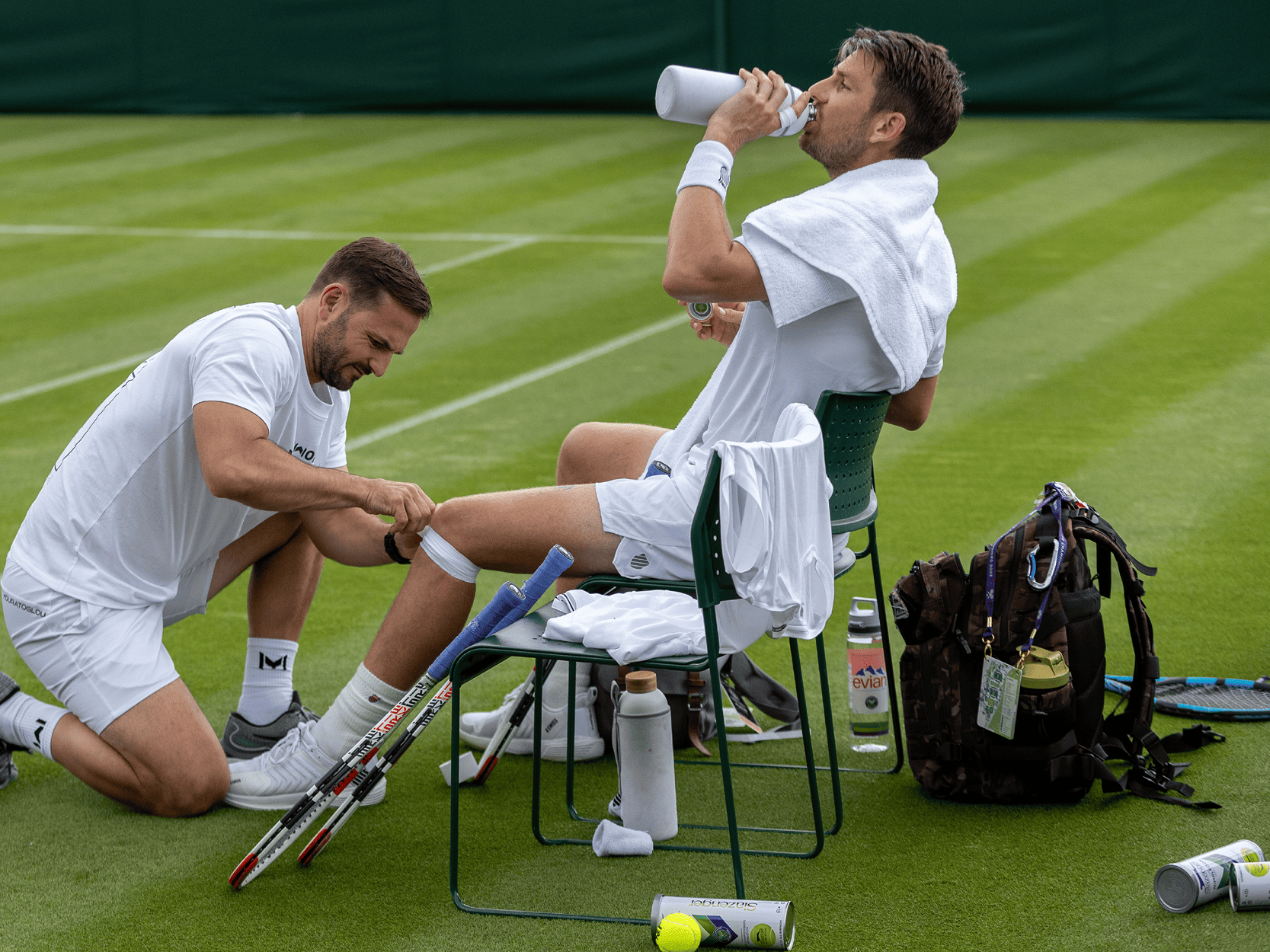 British tennis player Cameron Norrie getting physio treatment on court at Wimbledon