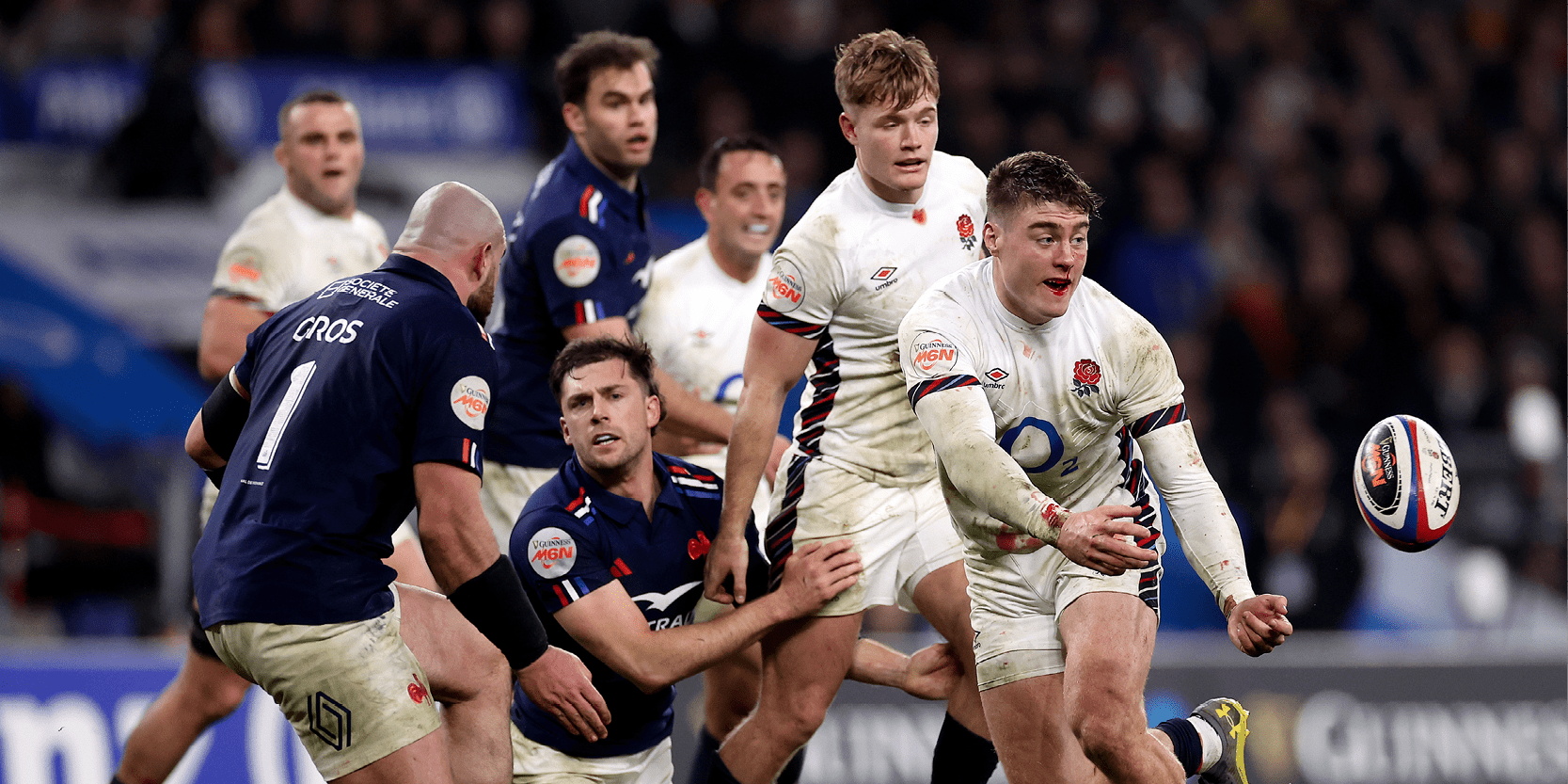 England Rugby team playing in a match against Scotland in the 2025 Guinness Men's Six Nations with Tommy Freeman passing the ball