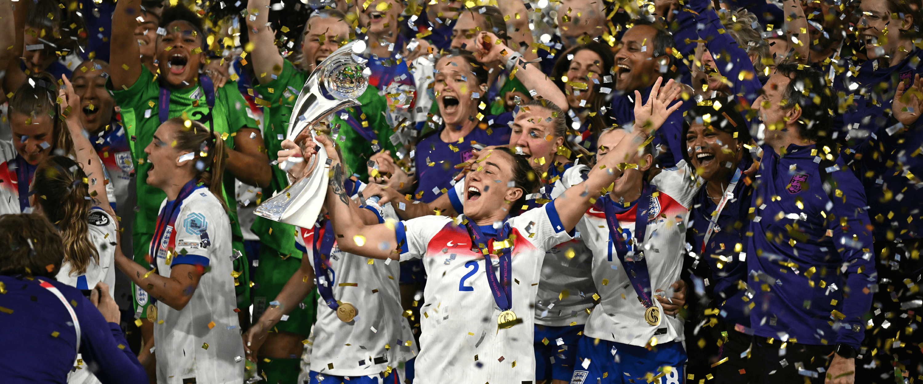 England's women's football team the Lionesses celebrating winning the Euro 2025 tournament holding the trophy on the pitch