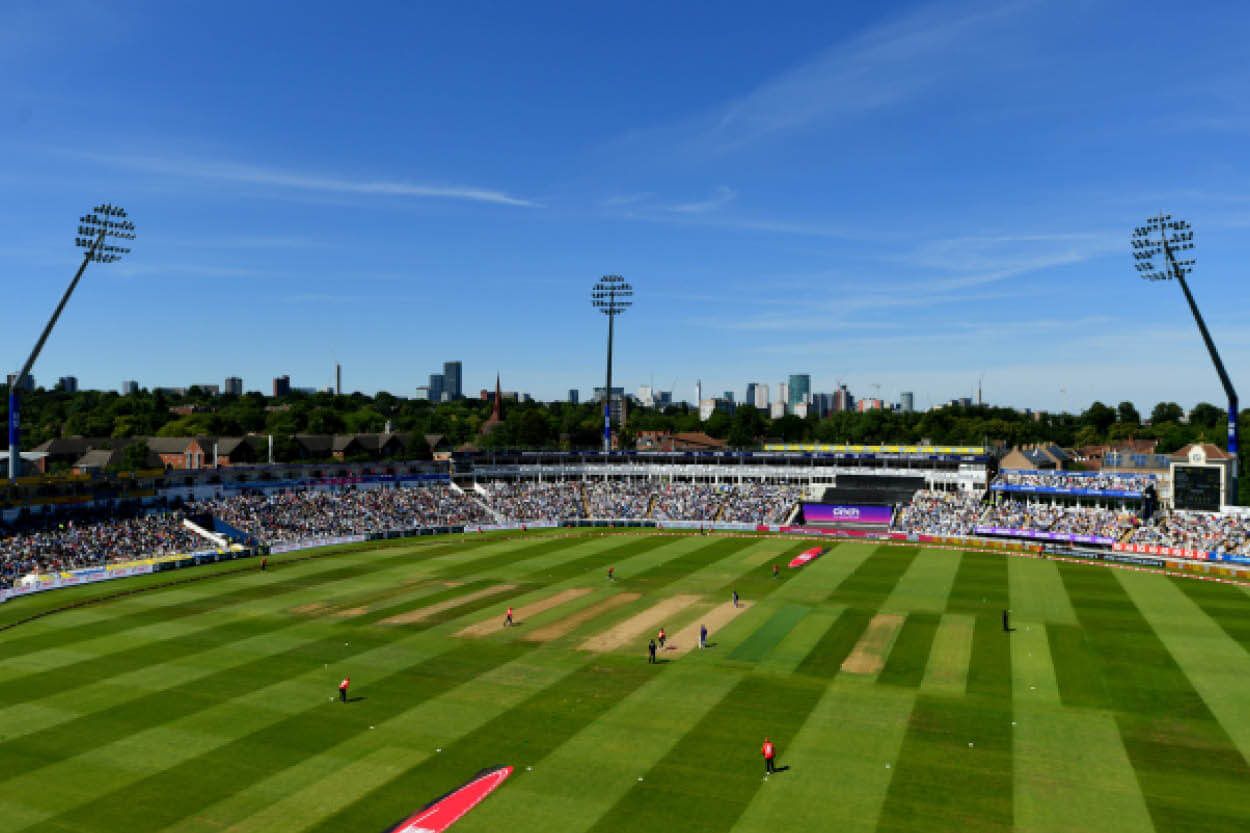 Panoramic view of the cricket pitch at Edgbaston Stadium with blue skies and a full crowd