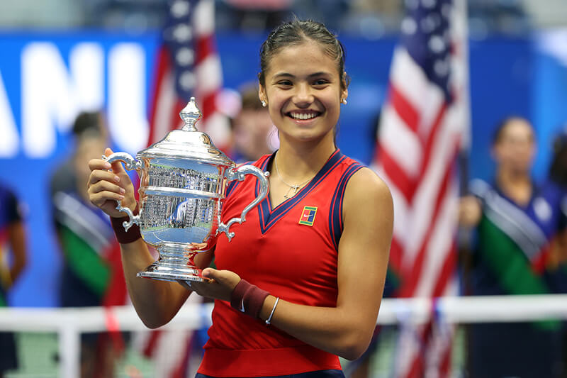 British tennis player Emma Raducanu holding the 2021 US Open championship Grand Slam trophy