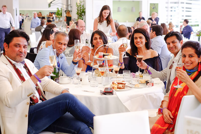 Guests on a table in The Lawn at Wimbledon enjoying a drink and their lunch served by two Michelin Star chef Michel Roux Jr 