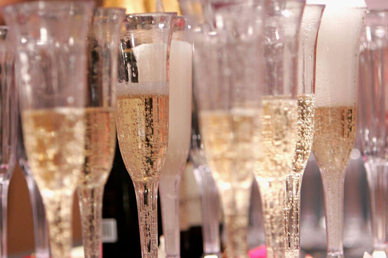Champagne glasses being served at an event
