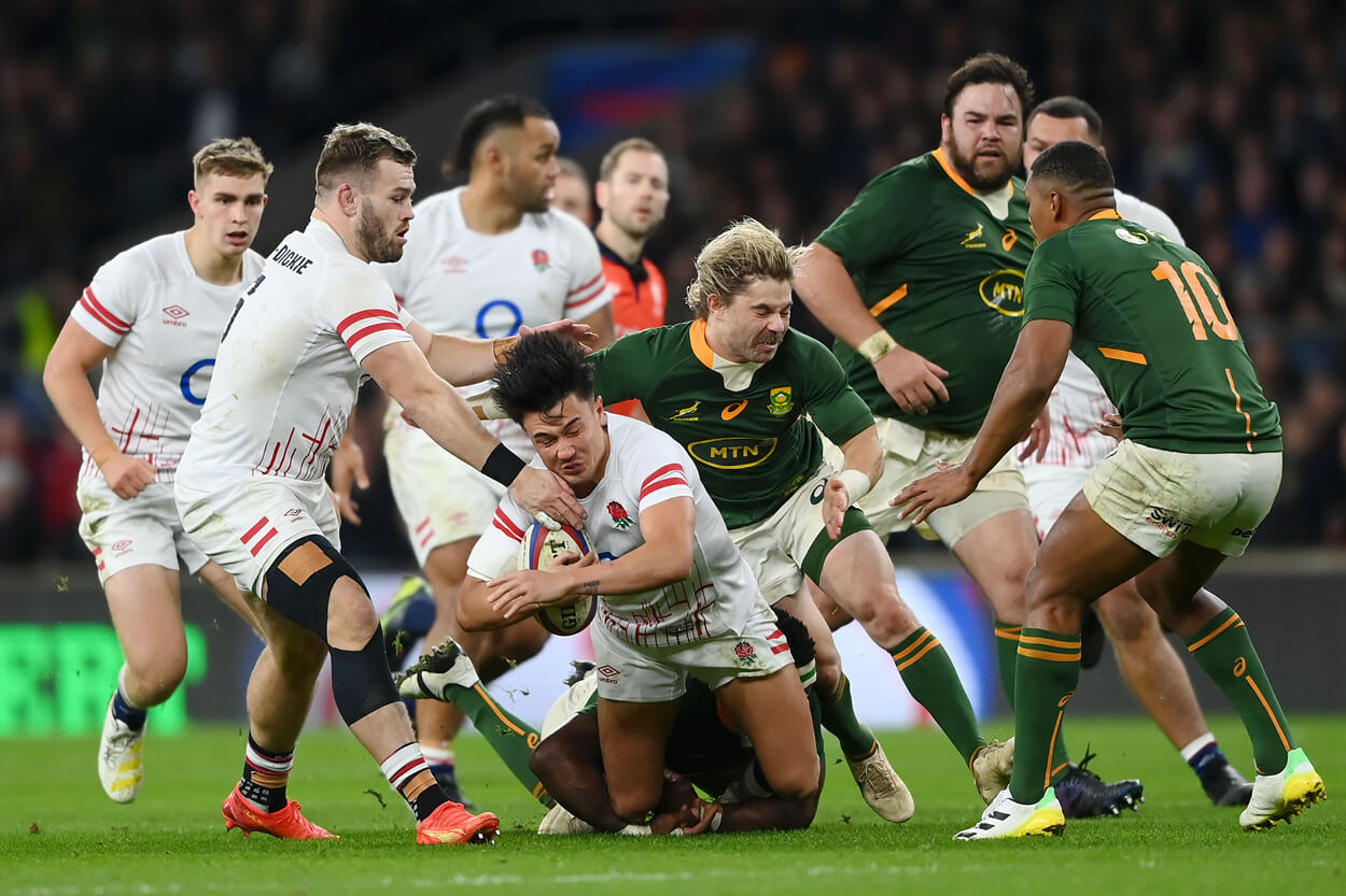 Marcus Smith with the ball being tackled by South Africa in the 2022 Autumn Nations Series at Twickenham Stadium