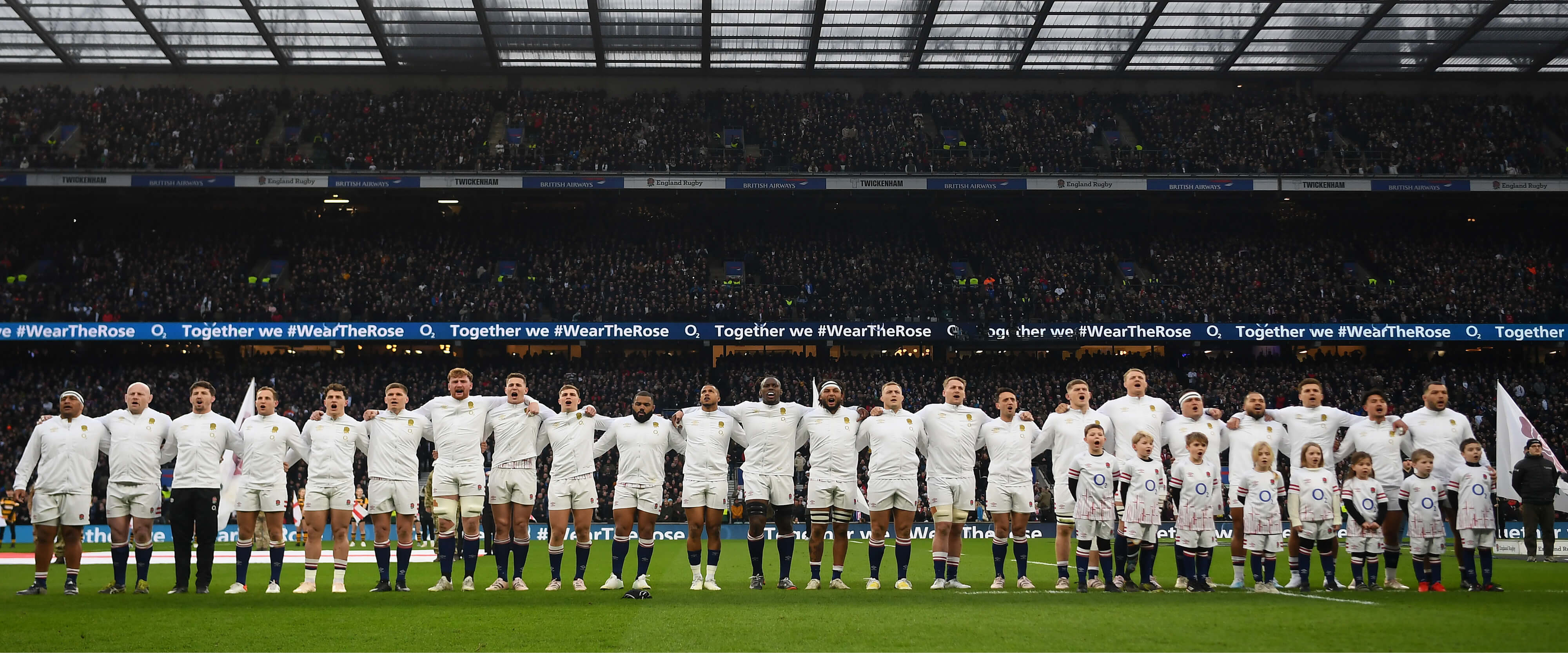 England men's rugby union team lining up before a match singing the national anthem at Twickenham Stadium