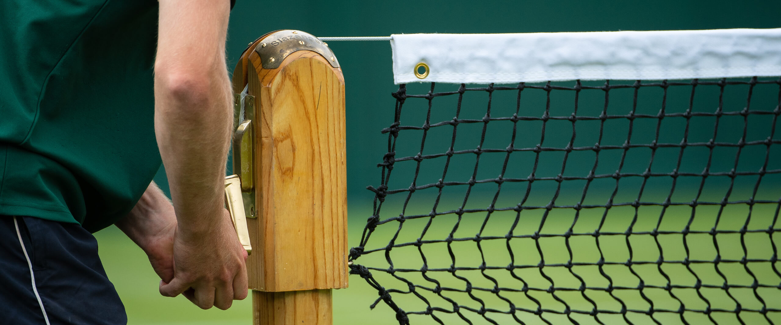 Groundsmen adjusting the tennis net at Wimbledon