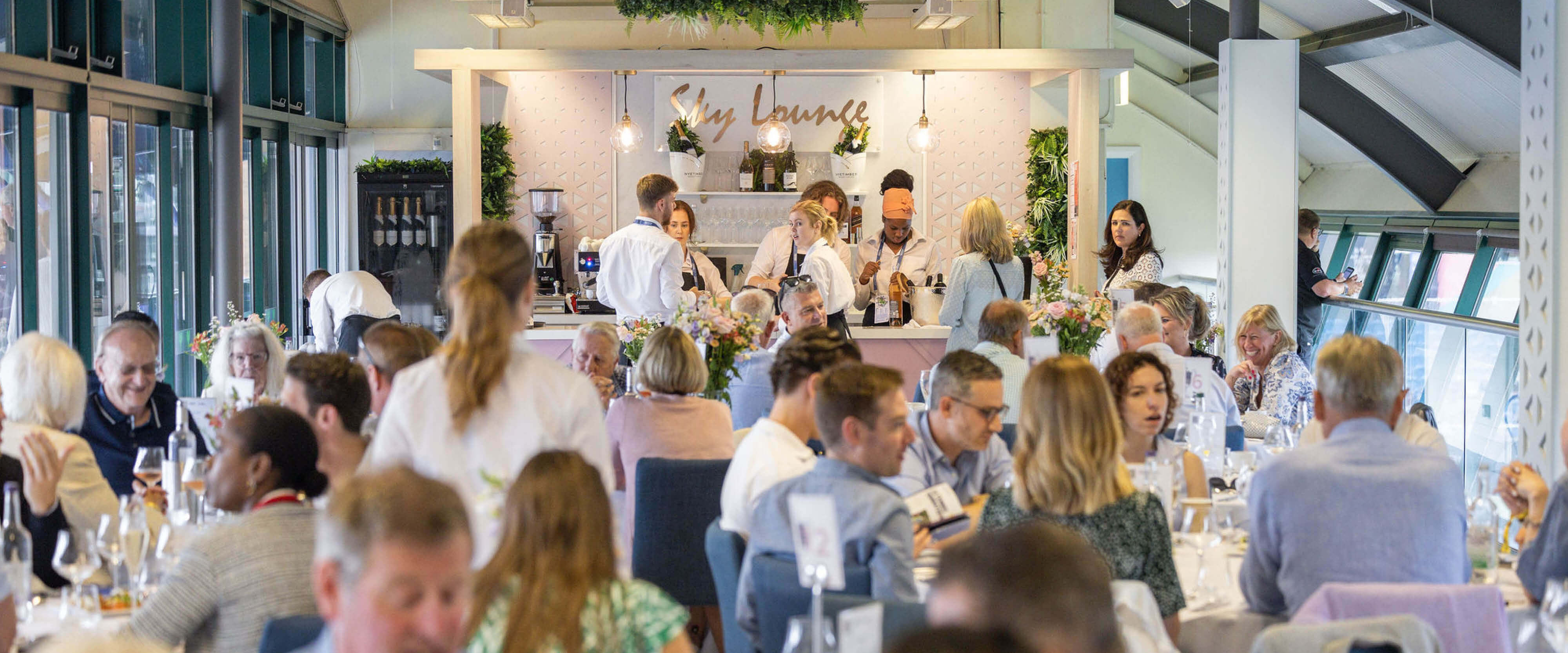 The Sky Lounge hospitality experience at Eastbourne International tennis tournament in Devonshire Park where guests are enjoying a meal and drinks before watching the tennis