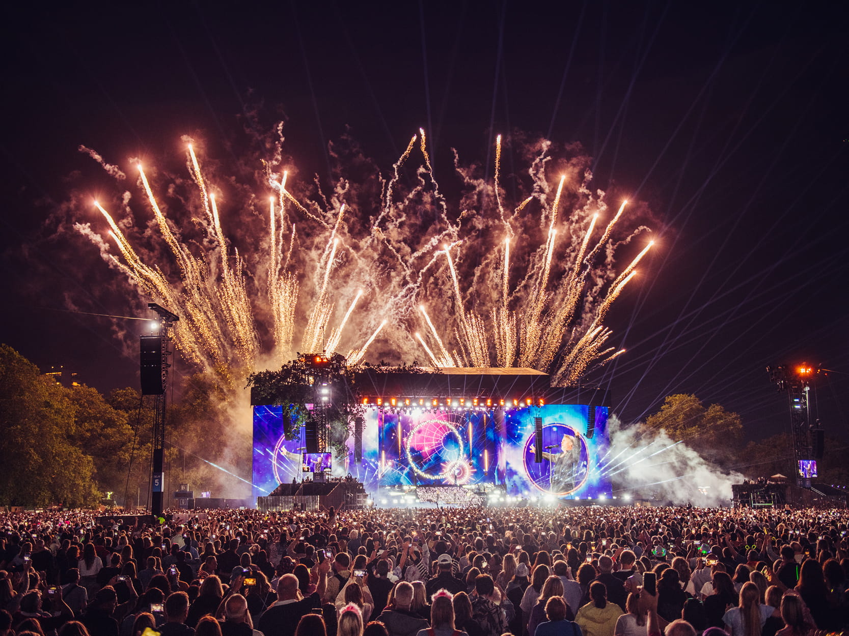 View of the main stage at American Express Presents BST Hyde Park with the crowd dancing and fireworks