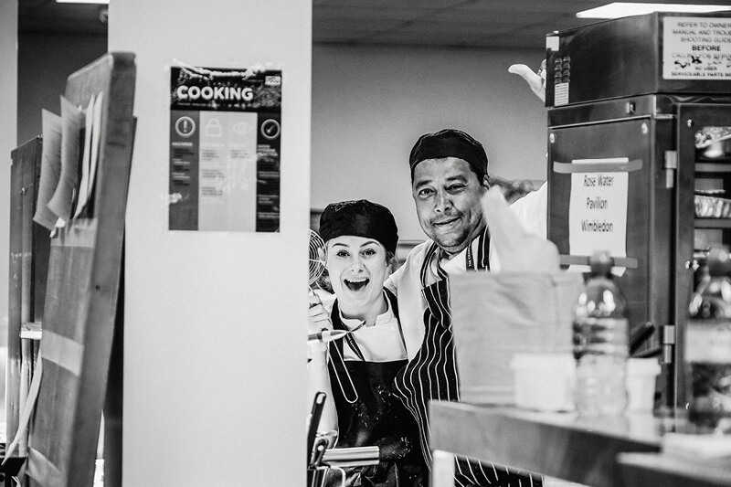 Chefs smiling in the kitchen at Wimbledon for Rosewater Pavilion hospitality