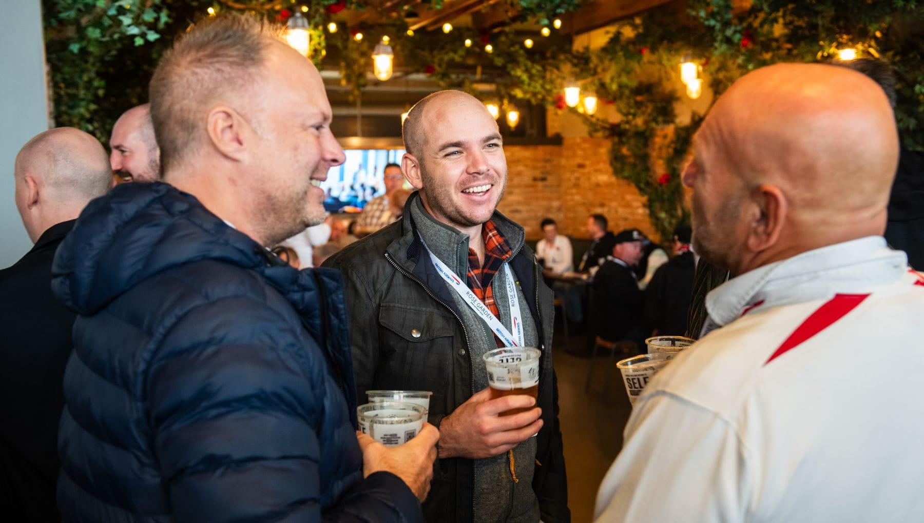 Guests standing with drinks talking 
