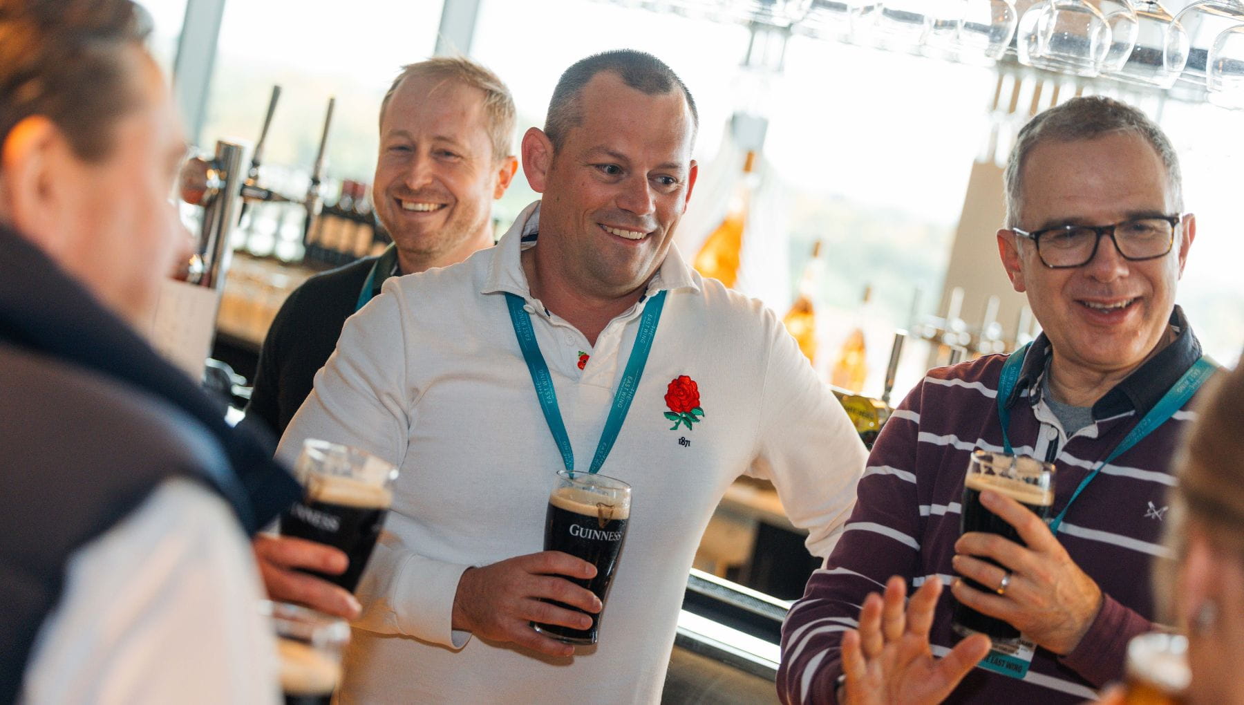 Guests standing with drinks talking in The East Wing