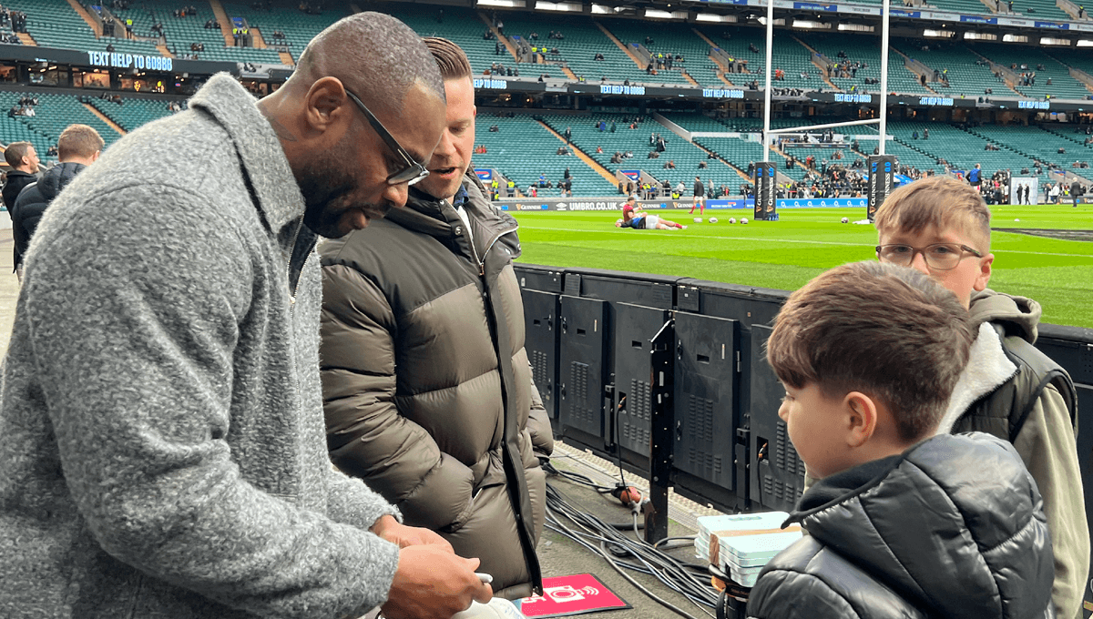 Ugo Monye signing a rugby hat for England rugby fans