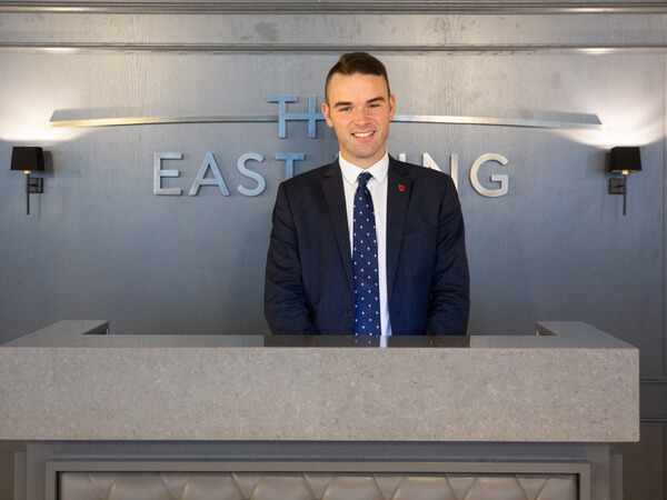 Service staff at the welcome desk in The East Wing